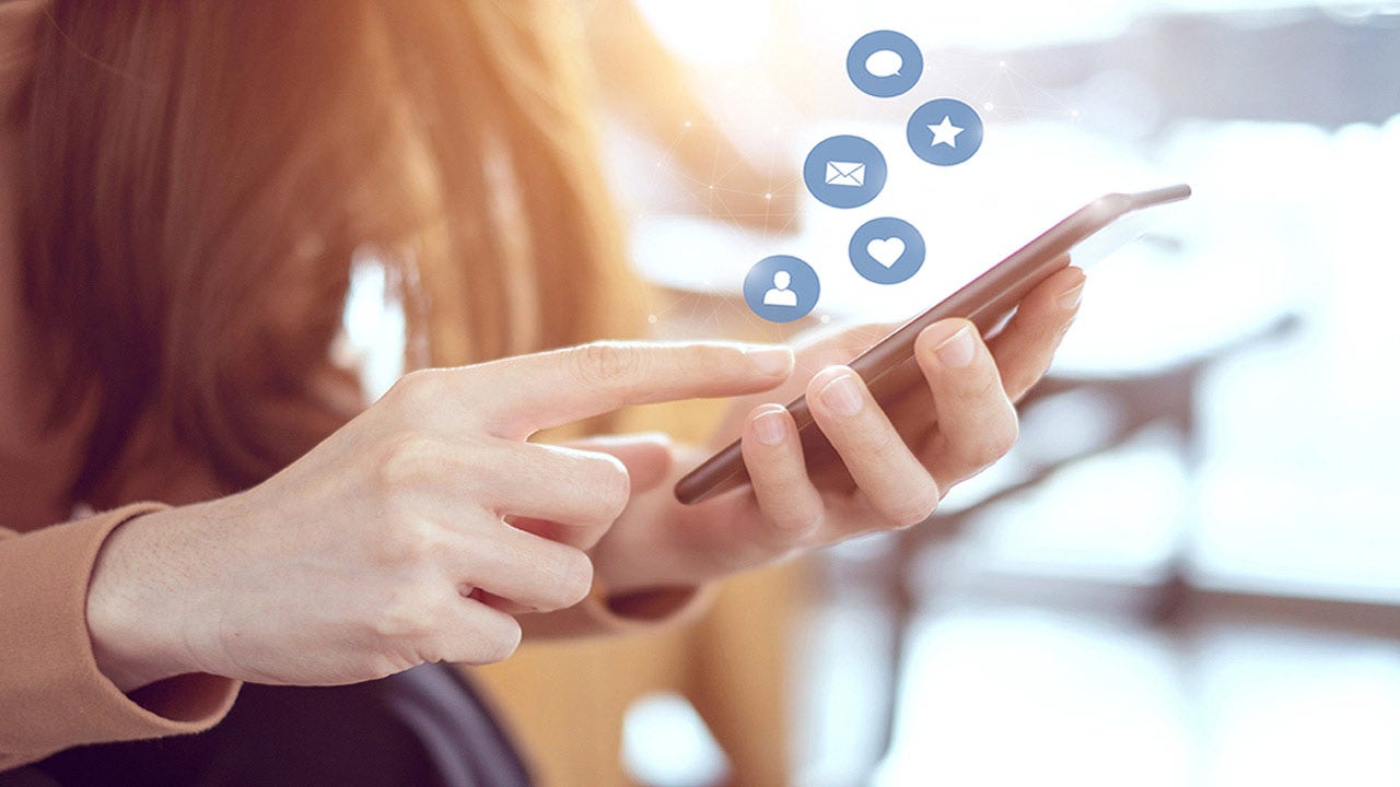 Woman hands using smartphone with icon social media.