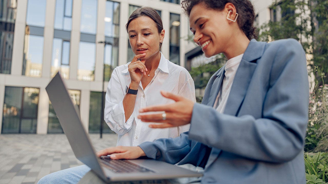 Two business coworkers working outside of an office