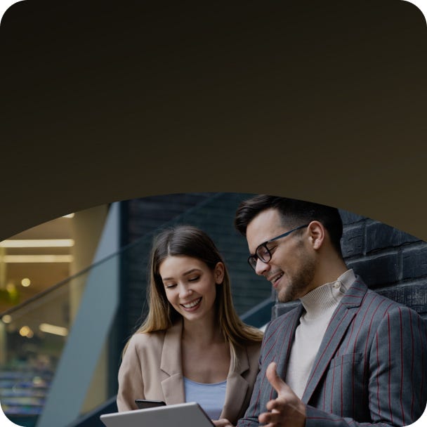 Man and woman looking at  tablet.